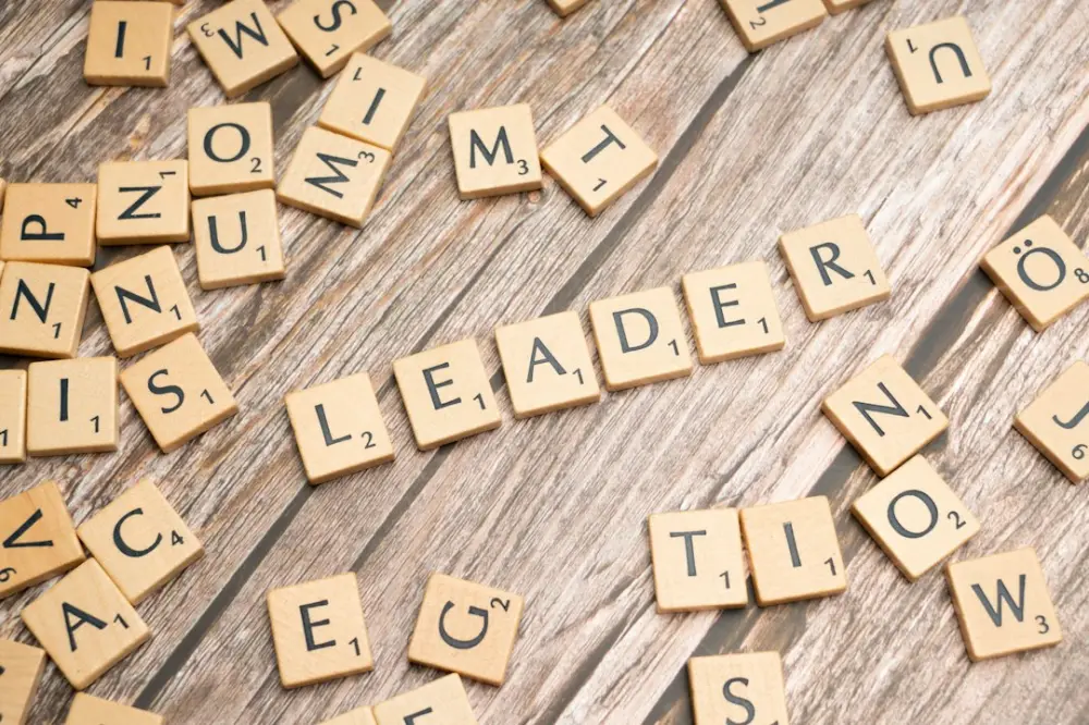 Scrabble tiles spelling out the word leader in a word, illustrating responding to setbacks as a leader